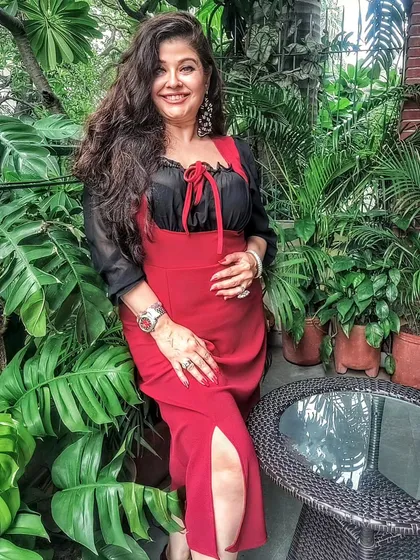 My Autumn collection is all about statement pieces. Here I'm wearing a red slit dress layered with a black chiffon top, showcasing how you can play with colors and layers to create a unique look.
