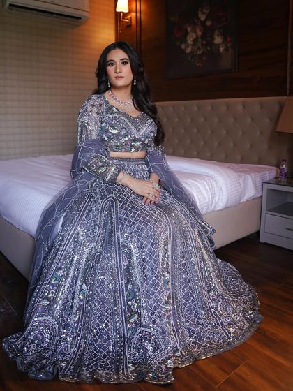 The cocktail glam of your dreams. This full shot shows how the dramatic makeup, featuring a bold eye, pairs perfectly with this intricate lavender lehenga for a show-stopping look.