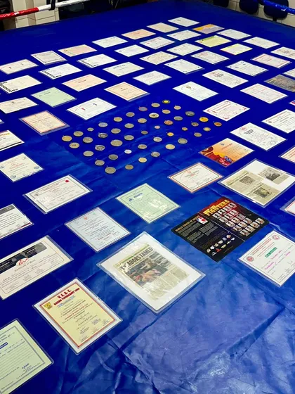 A close-up of my achievements spread across the ring. Each certificate and medal tells a story of dedication and hard work.