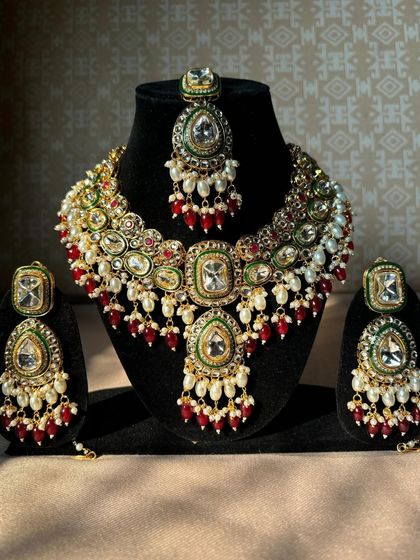 A frontal view of our multi-colour Kundan bridal necklace set. The combination of red, green, and white stones makes it a versatile choice that can match many outfits.