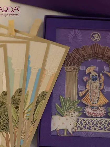 This image highlights the beautiful inserts that accompany our Shreenathji wedding invitation. The cards feature architectural and foliage motifs inspired by Pichwai art, creating a cohesive and artistic stationery suite.