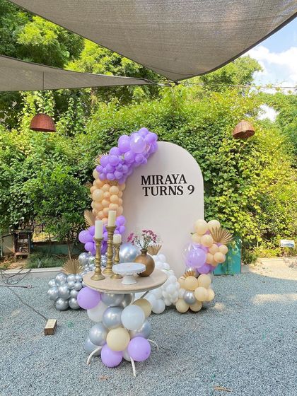 A wide shot of the outdoor 9th birthday party, showing the beautiful green surroundings.