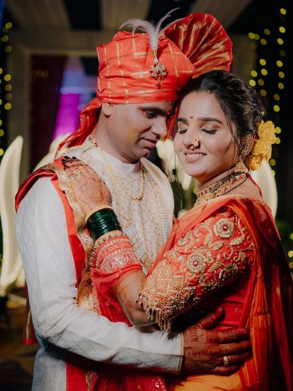 Another angle of a tender embrace, focusing on the bride's expression and the beautiful embroidery on her blouse.