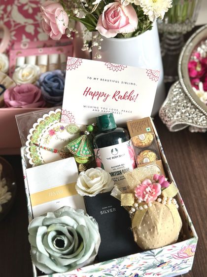 Celebrate Rakhi with this couple's hamper. It includes mini perfumes from Zara for him and her, a decorated nariyal (coconut), a lumba and rakhi set, Ferrero Rocher, and a Body Shop shower gel.