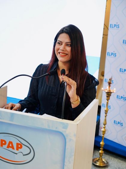 Speaking from the podium at the Elpis Auto meet. I deliver key messages with clarity while keeping the event engaging.