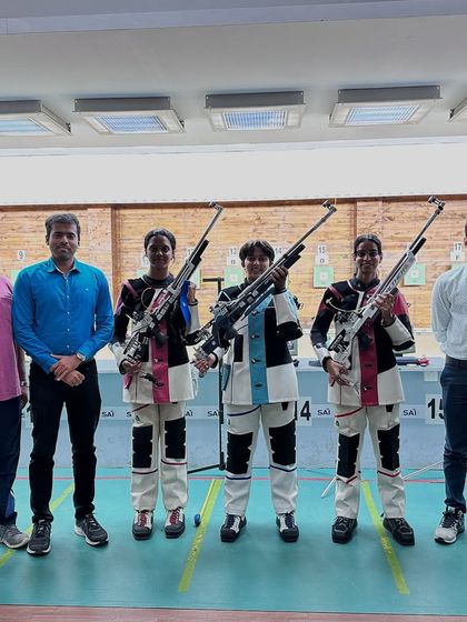 Our Air Rifle women's team with their coaches after Bhashitha's bronze medal win in the finals.