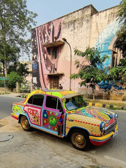 Art doesn't have to be confined to walls. This vintage Ambassador car was transformed into a vibrant canvas, fusing Indian truck art aesthetics with kitsch and maximalist design for a truly one-of-a-kind mobile masterpiece.