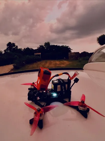 A beauty shot of one of my custom-built FPV drones against a dramatic sunset sky. I build and maintain my own gear.