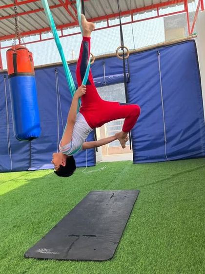 This pose is great for opening the hips and shoulders. The kids just think it's a cool way to hang upside down.