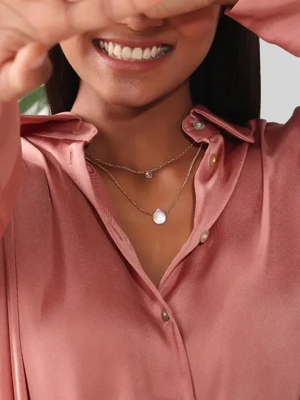 A detailed shot focusing on a delicate layered necklace. For jewellery photography, I use specific lighting and angles to capture the texture, shine, and fine craftsmanship of each piece.