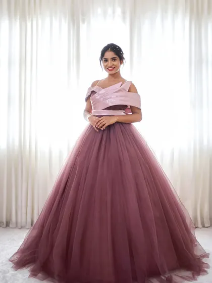 Feel like royalty in our Royalty gown. This dusty rose ballgown features a full tulle skirt and a modern, structured bodice.