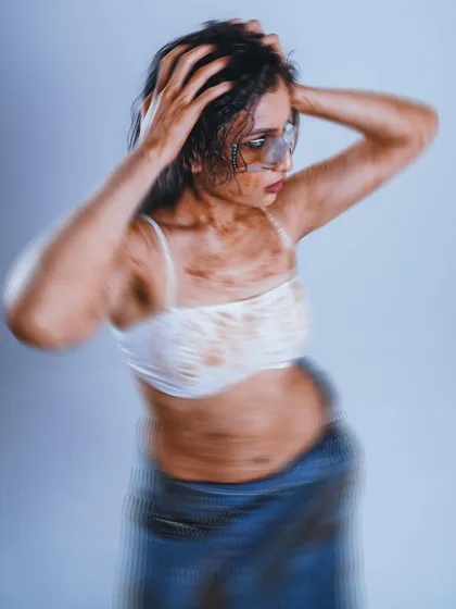 I used a slow shutter speed to introduce intentional motion blur in this shot. This technique adds a sense of dynamic energy and artistic flair to the image, making it a strong choice for an experimental fashion story.