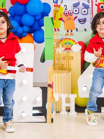 A charming 'Baby Shark' themed birthday party, featuring a vibrant underwater backdrop, character cutouts of the shark family, and blue and yellow balloons, perfect for a fun-filled celebration.