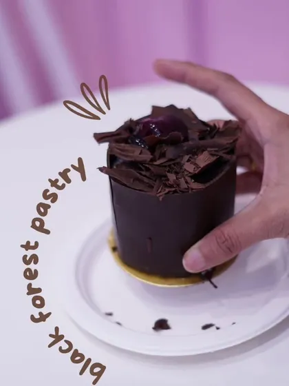 This is our take on the classic Black Forest pastry. It's a perfect single serving of rich chocolate cake, whipped cream, and cherries, all wrapped in a delicate chocolate shell.