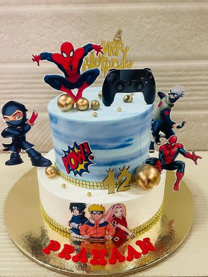 The ultimate crossover cake for a 12th birthday, combining the worlds of Spider-Man, Naruto, and gaming with a cool two-tier design and character toppers.