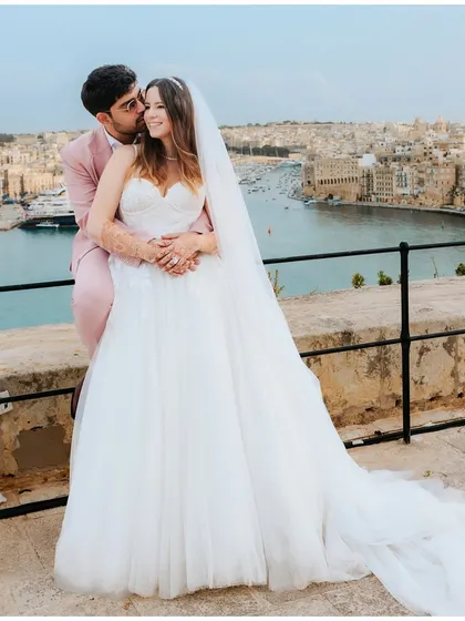 A romantic portrait of the couple against the stunning backdrop of Malta, their love story framed by the city and the sea.