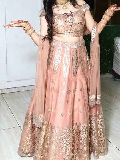 This image showcases the full twirl-worthy lehenga and the accompanying rental jewellery. The off-shoulder blouse draws attention to the statement necklace, making it a central part of the outfit.