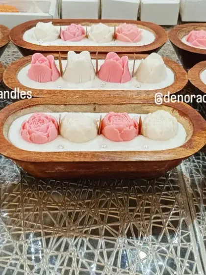 A batch of my wooden boat candles with pink and white rose wax flowers, ready for a customer order.
