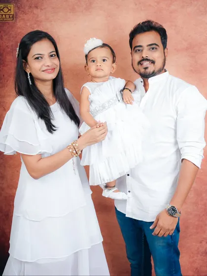 A beautiful formal family portrait, with everyone smiling for the camera.
