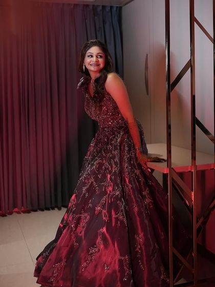 A dramatic shot with red lighting. The makeup still looks flawless and beautiful, showcasing its versatility under different lighting conditions.