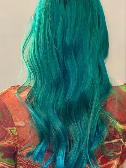 For those who love to stand out, we create vibrant, head-turning looks like this stunning sea green. This is a full-coverage fashion color that shows our expertise in bold and creative hair transformations.