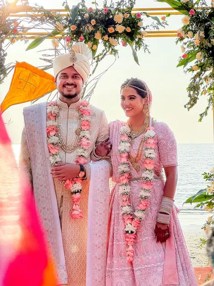 A beautiful beachside wedding in Goa, with the couple framed against the sea. We have extensive experience with destination weddings, capturing the unique beauty of locations like Goa to make your day unforgettable.