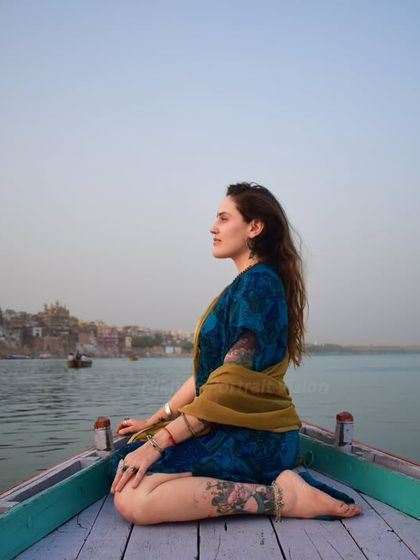 Serenity in the soul, Ganga in the heart. A traveler finds her moment of peace, meditating on a boat as it drifts along the Varanasi ghats.
