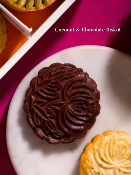 A beautifully molded Coconut & Chocolate Biskut. The rich, dark chocolate pastry features an intricate floral design, showcasing the artistry that goes into each piece.