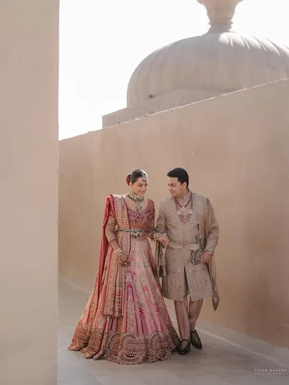 A quiet walk through the sunlit corridors of Fairmont Jaipur. My styling focused on the beautiful contrast between the couple's soft pastel Tarun Tahiliani outfits and the grand, monolithic architecture of the palace.