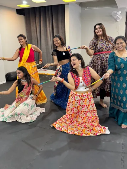 Posing with our dandiya sticks. These props add an extra layer of fun to our Navratri workouts.