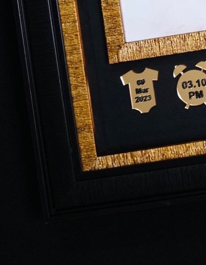 It is all in the details. These small, golden charms record the baby's birth date and time, adding a very personal and informative element right into the artwork.