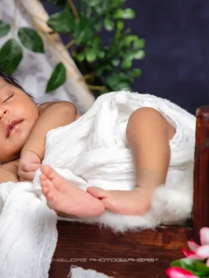 A peaceful sleep in a rustic bed. I love the combination of the dark wood, the soft white fur, and the simple wrap to create a timeless and natural portrait.