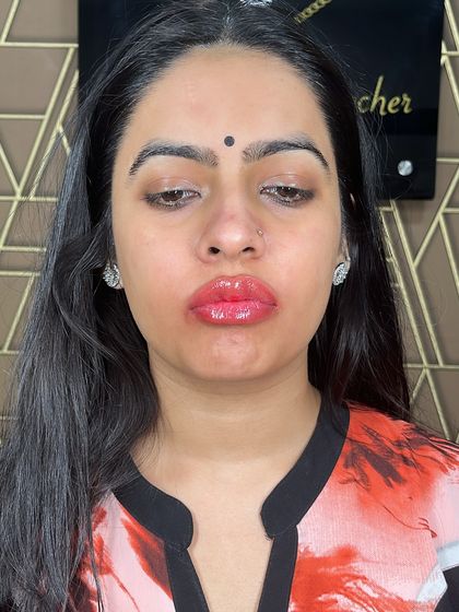 A full-face view of a client after her lip blush treatment. The color adds a beautiful focus to her features and looks effortlessly natural.