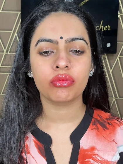 A full-face view of a client after her lip blush treatment. The color adds a beautiful focus to her features and looks effortlessly natural.