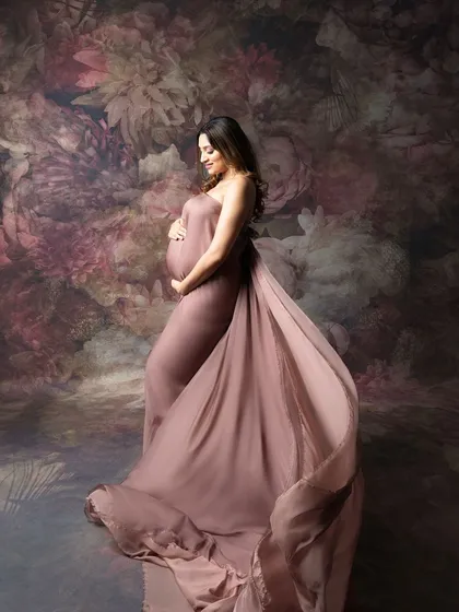Capturing someone’s new chapter filled with love and tiny kicks. This mom-to-be looks effortlessly gorgeous in this flowing gown against a floral backdrop.