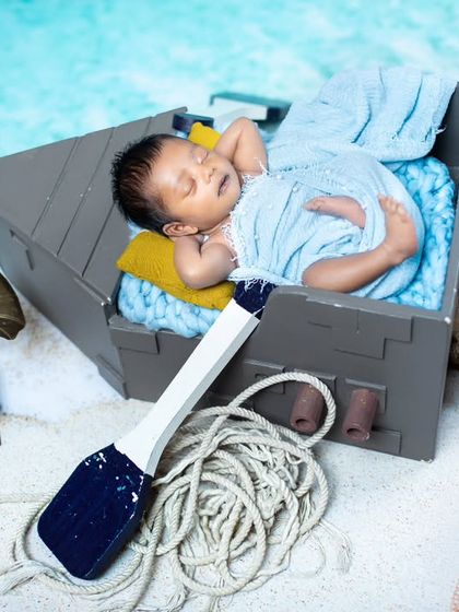 This little sailor is sleeping in his boat, surrounded by fishing nets and a vintage gramophone.