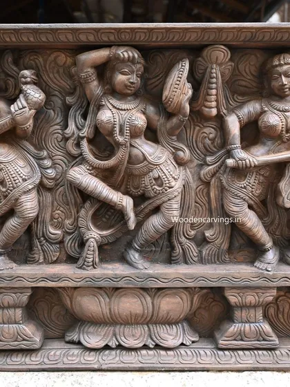 This close-up shows the central figure in the Apsara panel, a dancer applying kumkum. The sense of movement and the delicate details of her jewelry and expression are masterfully executed.
