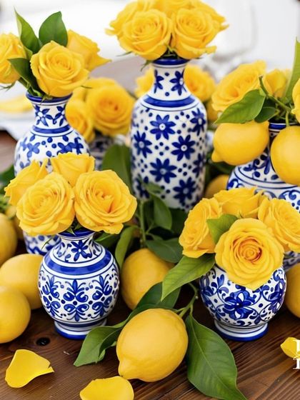 An arrangement of yellow roses in blue and white ceramic vases, scattered with fresh lemons. This simple yet beautiful detail perfectly encapsulates the theme.