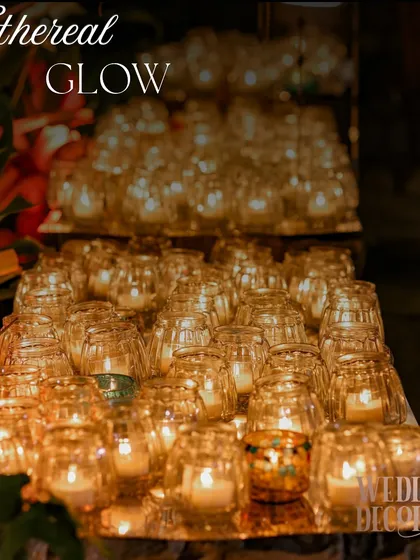 A mass of votive candles grouped together on a mirrored platform. This simple concept creates a powerful and warm source of light that feels incredibly luxurious.