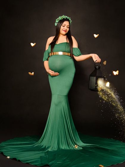 A magical solo portrait in a deep green gown. We used a lantern prop with sparkling light effects to add a touch of fantasy to this dark and moody shot.