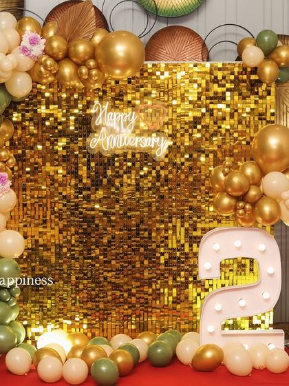 Another angle of the 25th-anniversary decor, highlighting the lush balloon garland and the warm glow of the light-up numbers.