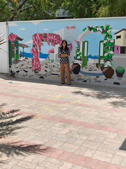 A wider shot of me with the mural, showing the full length of the painted wall.