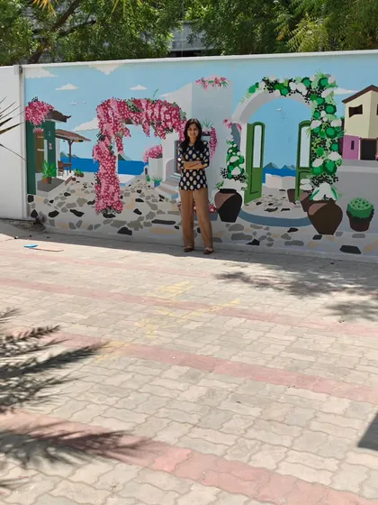 A wider shot of me with the mural, showing the full length of the painted wall.
