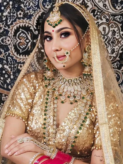 A full view of the bride in the golden sequin lehenga, showing how the jewellery complements the entire outfit.