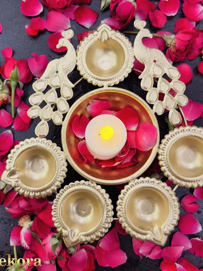 This elegant brass urli set features two peacocks and multiple diyas, making it a beautiful centerpiece for festive decor. It is a thoughtful and traditional gift, perfect for celebrating Diwali in offices or homes.