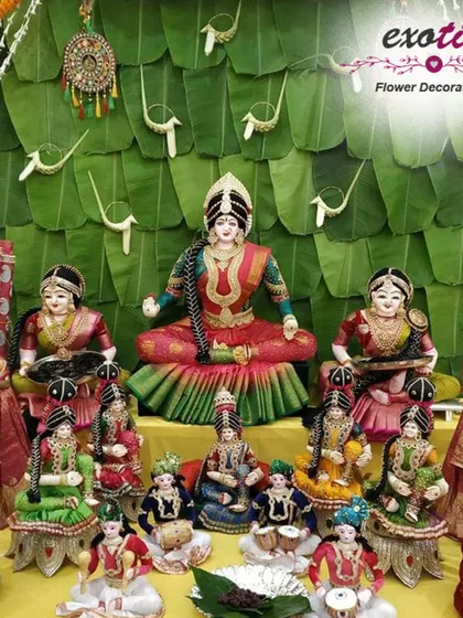 A traditional South Indian Golu display for Navratri, set against a backdrop of fresh banana leaves. This arrangement showcases a beautiful collection of dolls depicting various deities and scenes.
