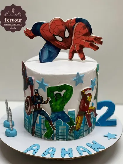 An action-packed Marvel theme cake for a 2nd birthday. This chocolate mousse cake is decorated with popular Avengers like Spider-Man, Hulk, and Iron Man, perfect for a little superhero fan.