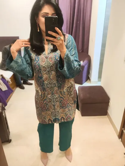 A mirror selfie showing the full outfit. I picked a contrasting pink from the paisley pattern for my stone earrings and heels, tying the whole look together.