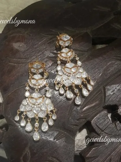 These tiered polki chandelier earrings are designed for a grand, dramatic effect. The multiple layers of uncut diamonds create beautiful movement and catch the light from every angle.