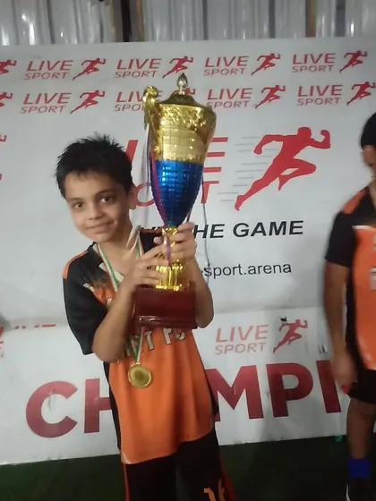 One of our youngest champions holding the trophy after the U9 Junior League win.